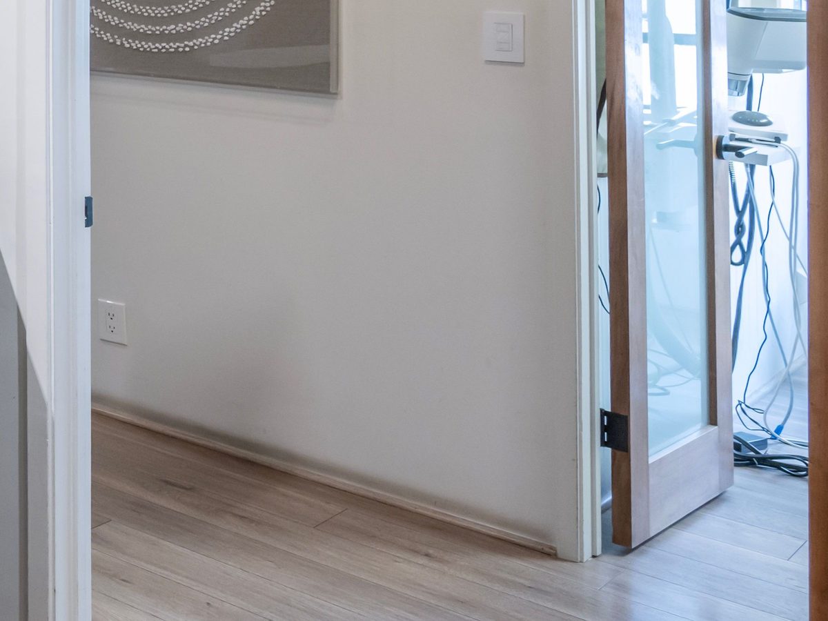 A level floor continuing through an open doorway in a bright room.