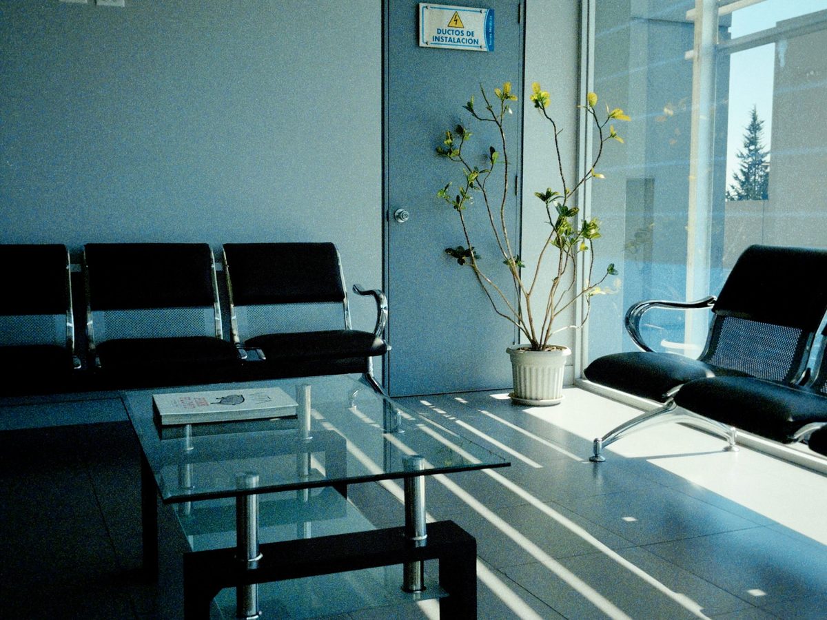 Empty seats beside a window in a waiting area.