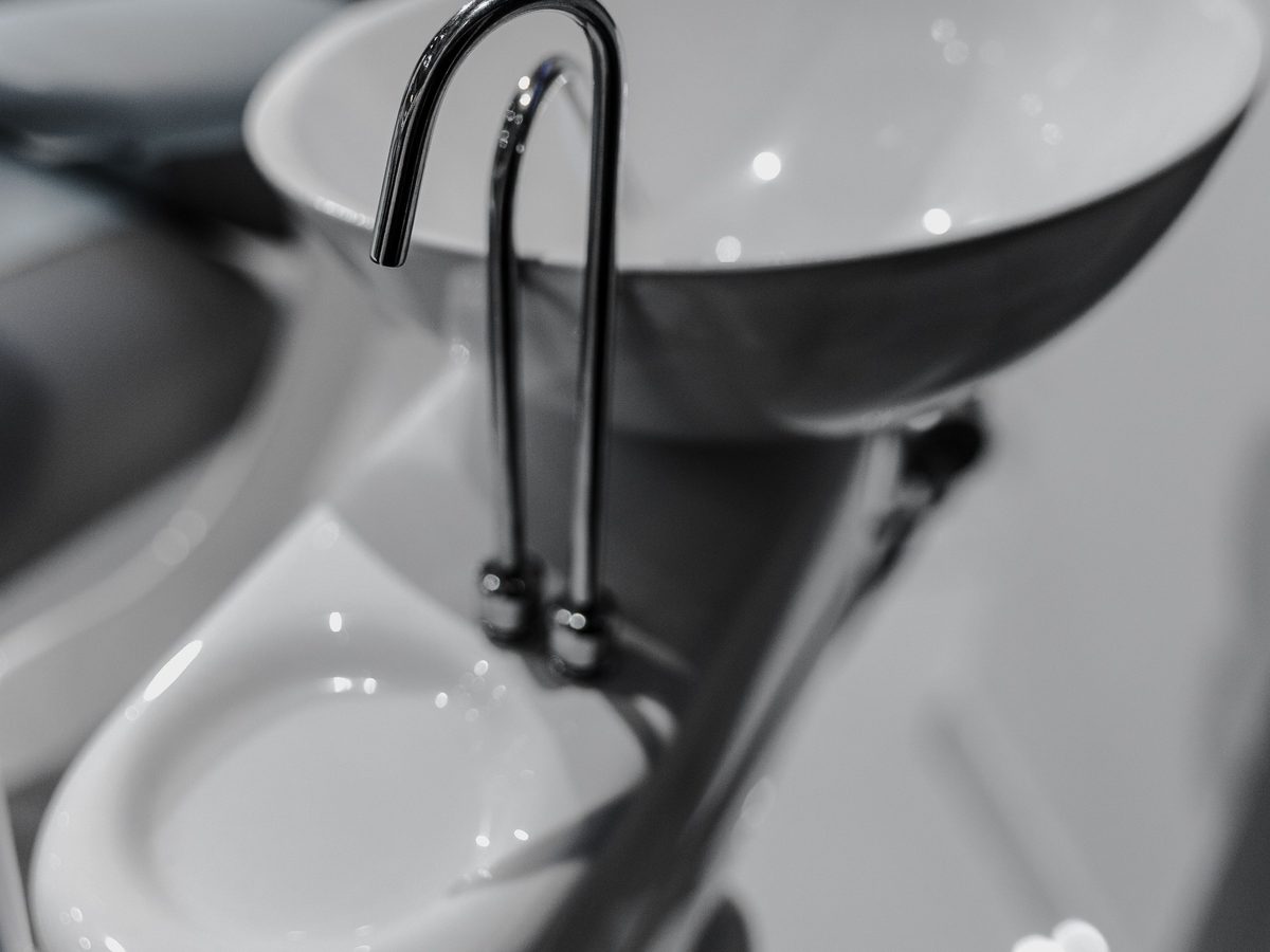 An empty dental wash area with a basin and tap.